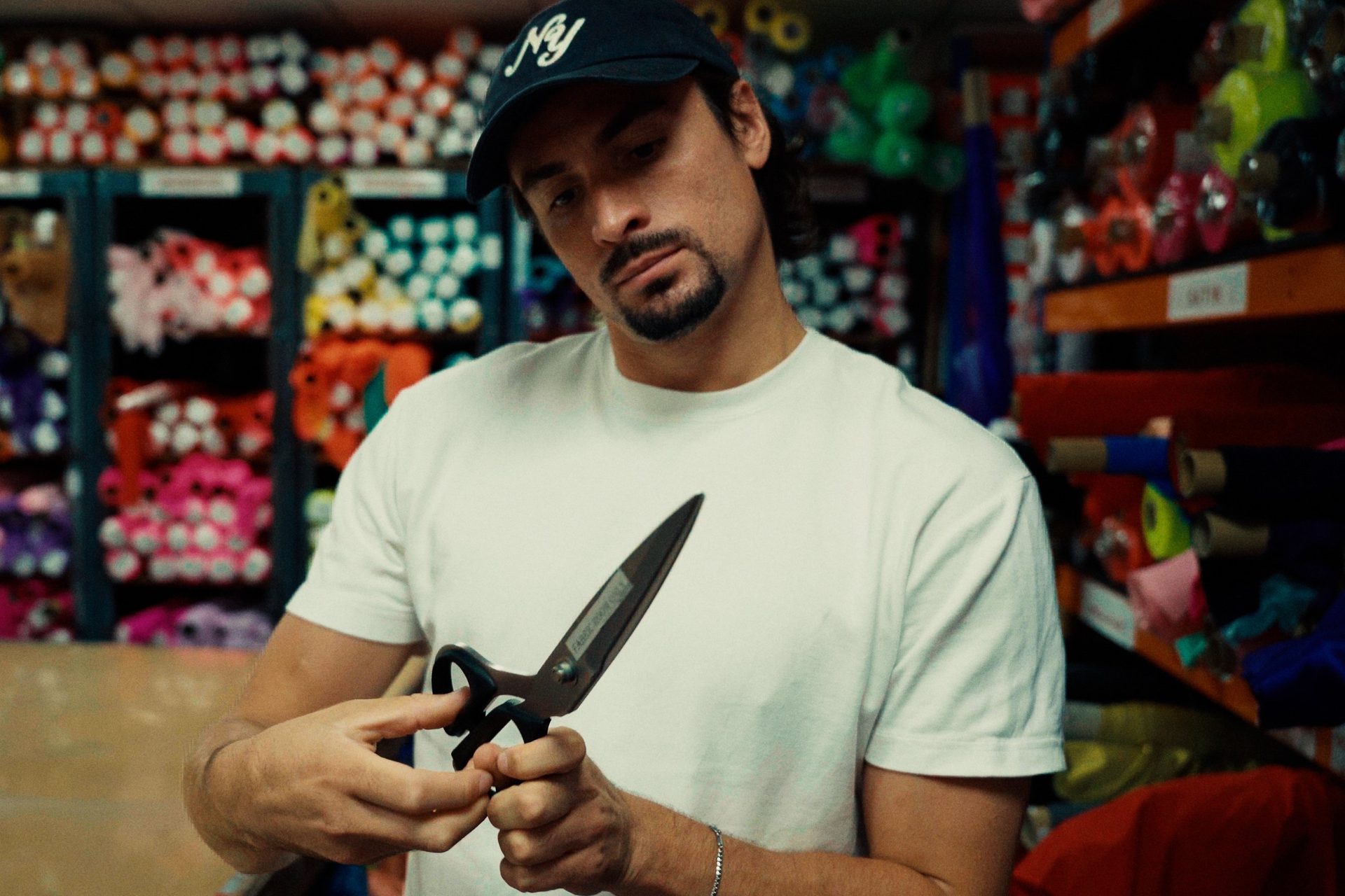 Jack holding fabric shears in a fabric room